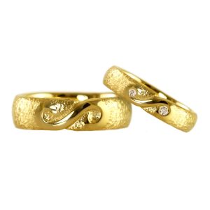 Wedding rings with infinity symbol. The symbol is polished while the rings have a raw surface