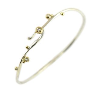 Simple silver bracelet with gold bubbles and white sapphires.