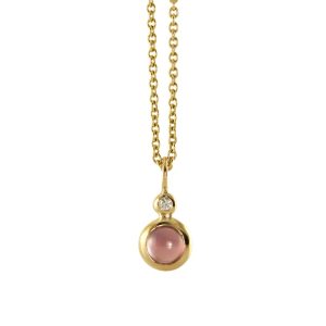 Simple pendant for a necklace with two bubbles, a small one on top of a large one. A white diamond is set in the small bubble and a round cabochon cut pink garnet is set in the large bubble.