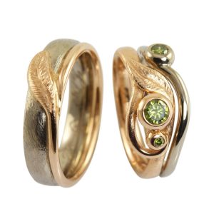 Unique wedding rings in rhodium-plated white gold with rose gold details, leaves, swirls and green diamonds