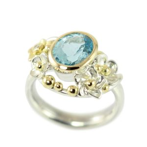 Sumptuous silver cocktail ring with gold bubbles and a large blue topaz